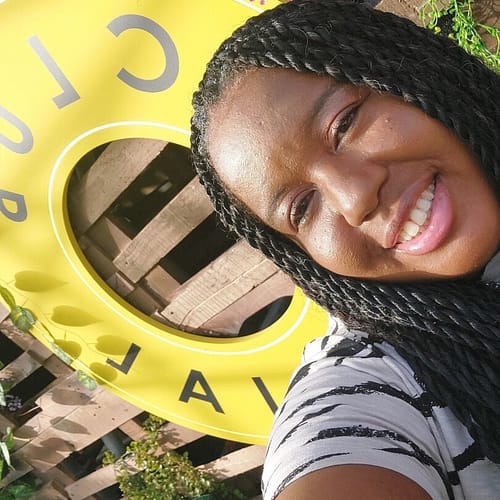 A selfie in front of the club social sign in the seated area of the venue. 